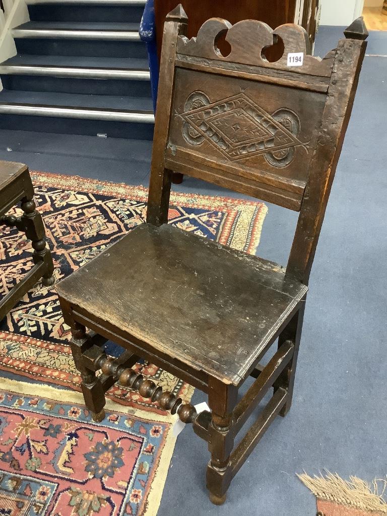 An 17th century oak back stool with lozenge carved decoration, width 48cm, depth 38cm, height 96cm